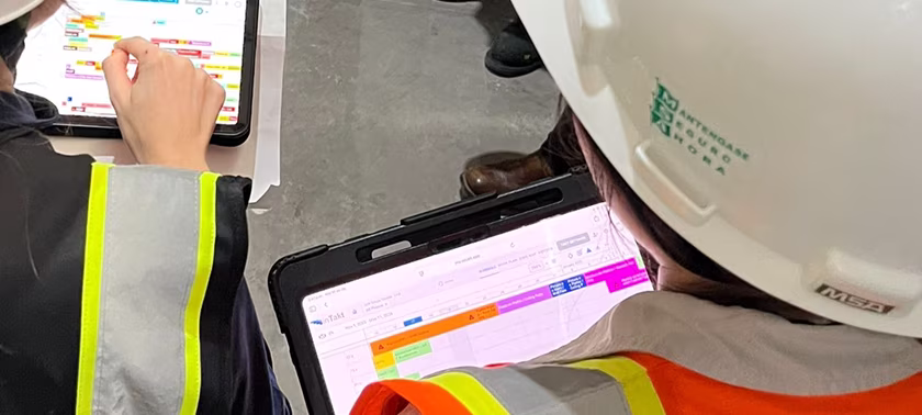 Takt planning consultant reviewing inTakt schedule on a tablet at a construction site
